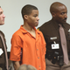 Sniper suspect Lee Boyd Malvo (C) is escorted by deputies as he is brought into court to be identified by a witness during the murder trial in courtroom 10 at the Virginia Beach Circuit Court October 22, 2003, in Virginia Beach, Va.